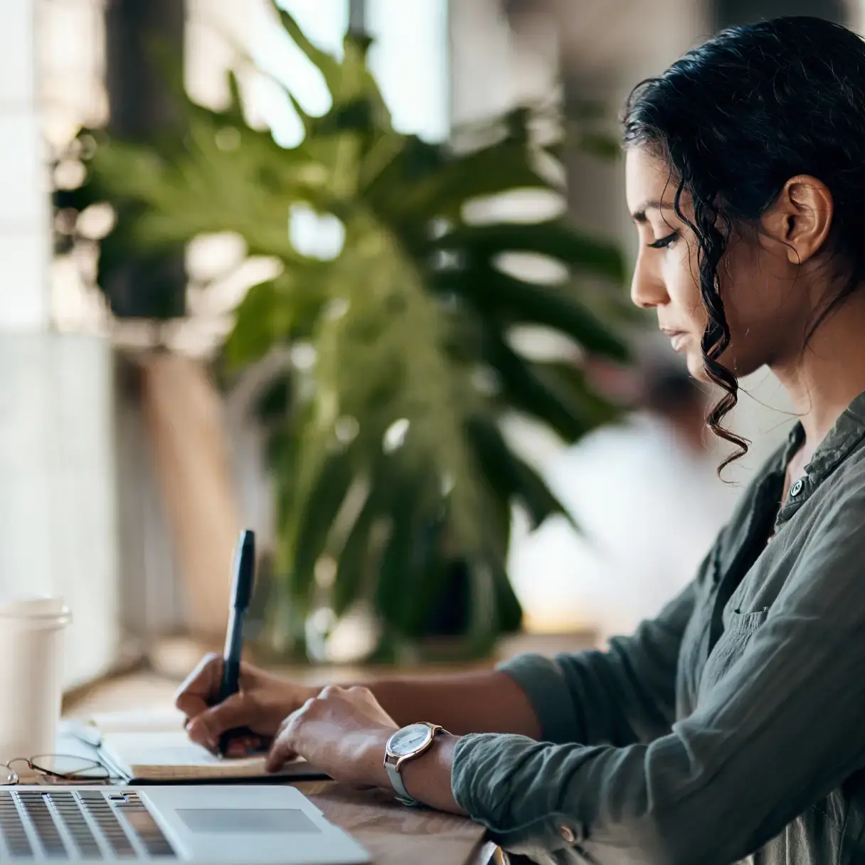 Woman taking notes from an online course