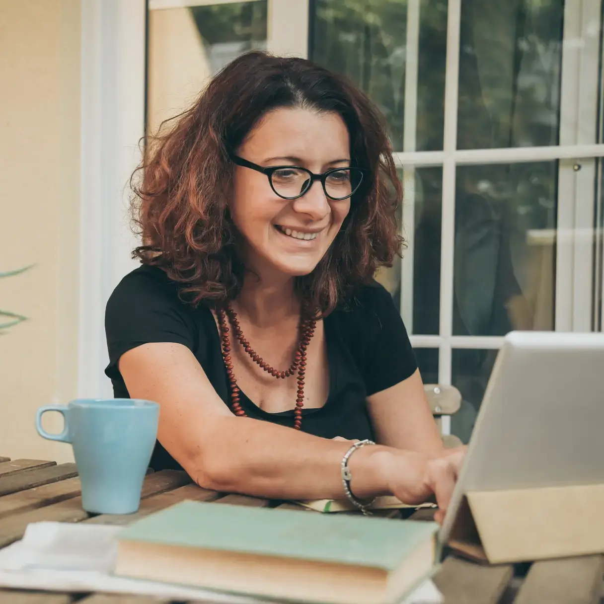 Woman with glasses studying at a laptop
